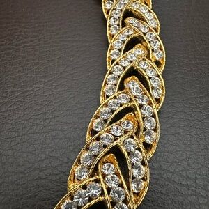 Nolan Miller gold tone bracelet with white crystals